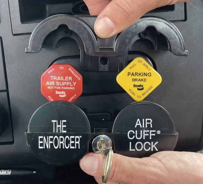 Air cuff lock labeled 'The Enforcer' being used on a vehicle's ignition switch.