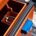 Orange tool box with a blue latch, showing a close-up of the latch mechanism.